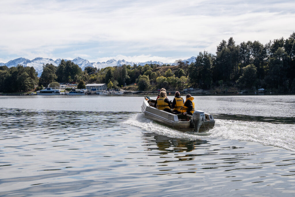 a group of people in a boat on a lake