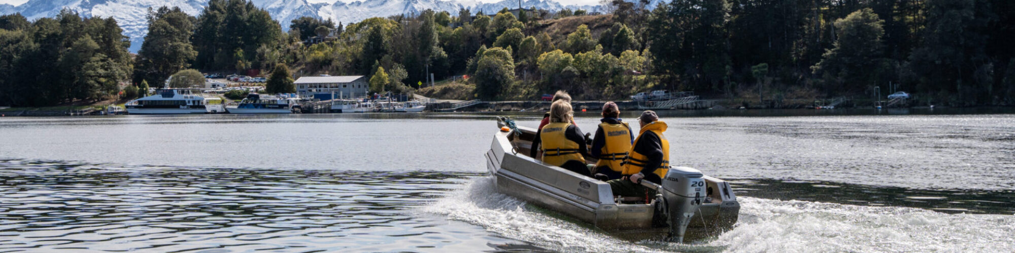 a group of people in a boat on a lake